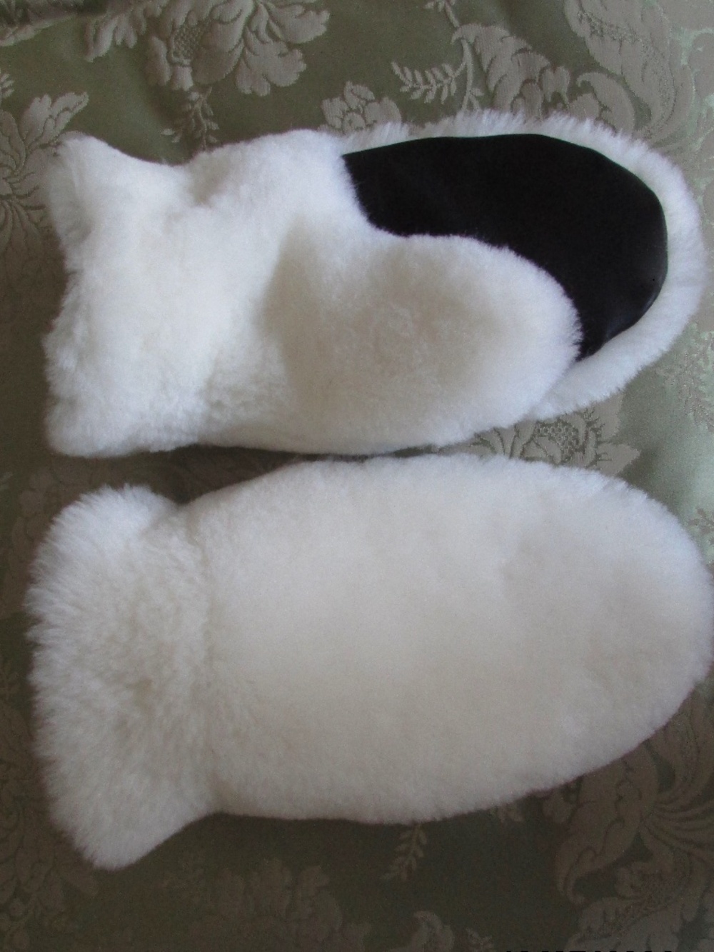 Mittens made from white sheep skin and black leather